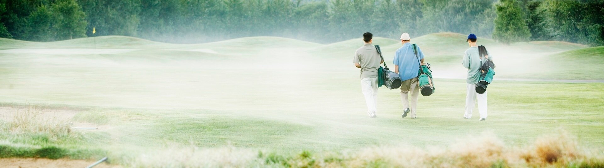 Men walking on golf fairway